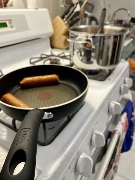 Cooking sausages on stove